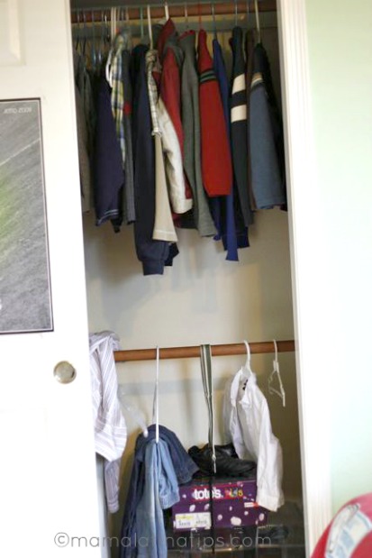 The interior of a closet with kids clothes.