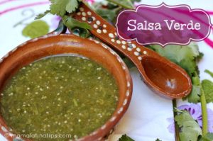 A tomatillo salsa verde recipe in a Mexican bowl with a spoon.