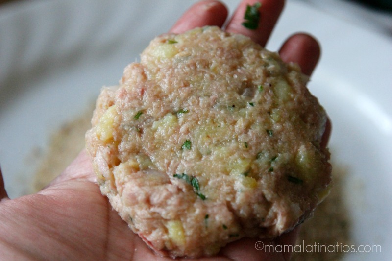 A raw tuna cake on top of a hand