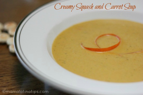 Creamy squash and carrot soup in a large white bowl.