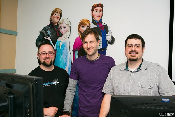 3 members of the Frozen rigging team in front of a mural with characters from the movie 
