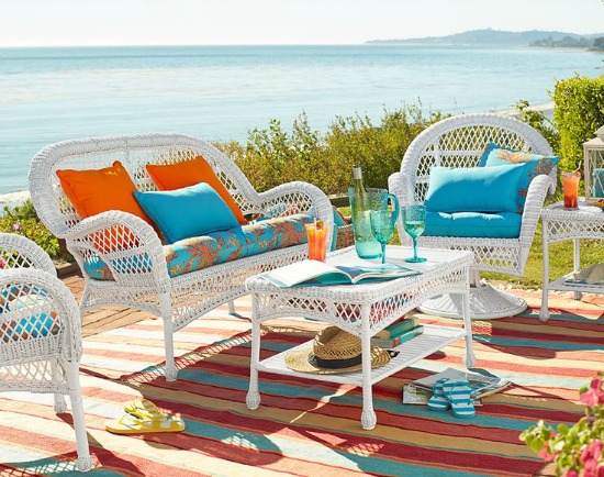 White outdoors sitting with orange and turquoise pillows