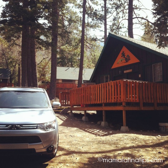 Mitsubishi Outlander in front of cabin
