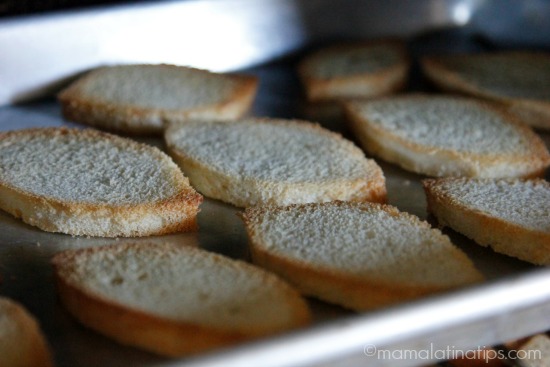 Toasting bread for bacon and bean crostinis