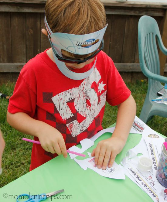 Kid making a paper rocket