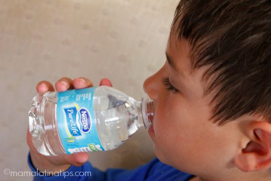 little kid drinking from a water bottle