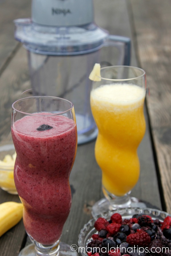 berry smoothie and pineapple smoothie on a wooden table