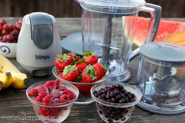 Ninja food processor and fruit on a wooden table