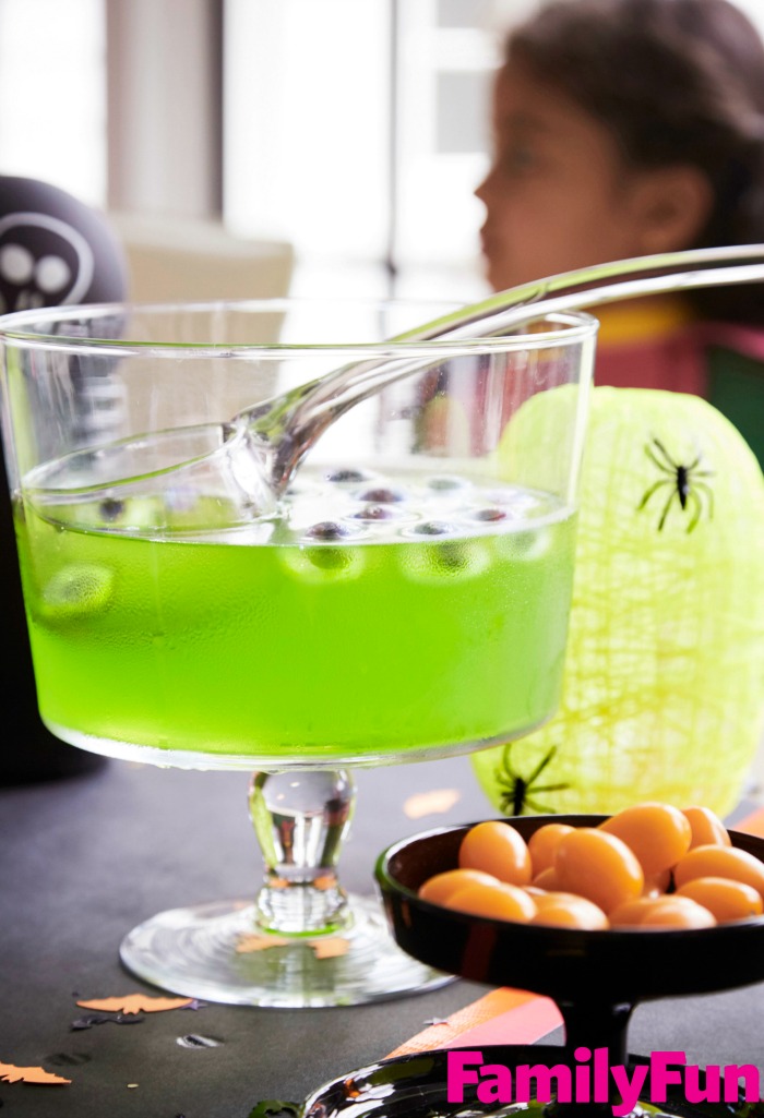 Green punch for Halloween with blueberry eyes