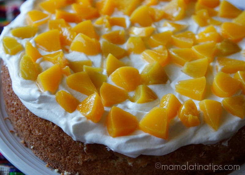 tres leches cake with peaches and whipped cream