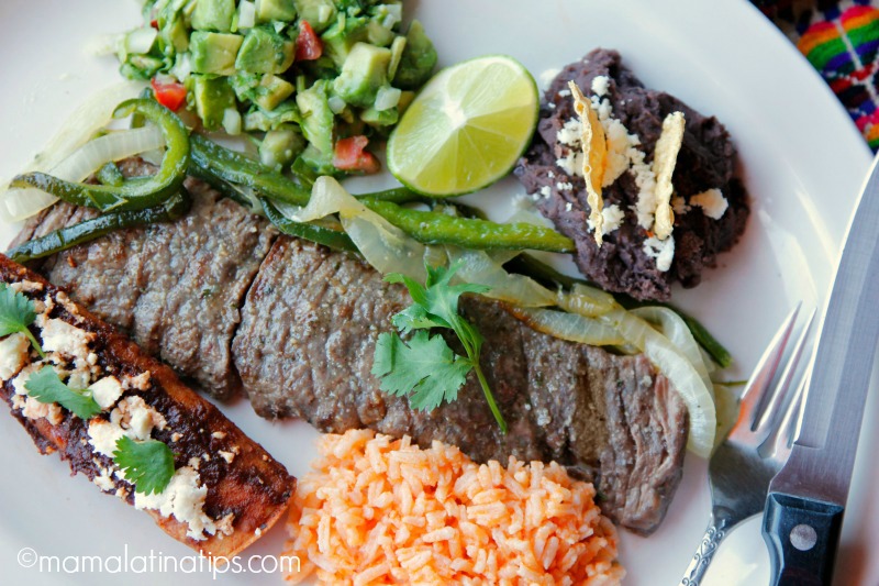 carne asada tampiqueña with guacamole, red enchilada, rice and beans