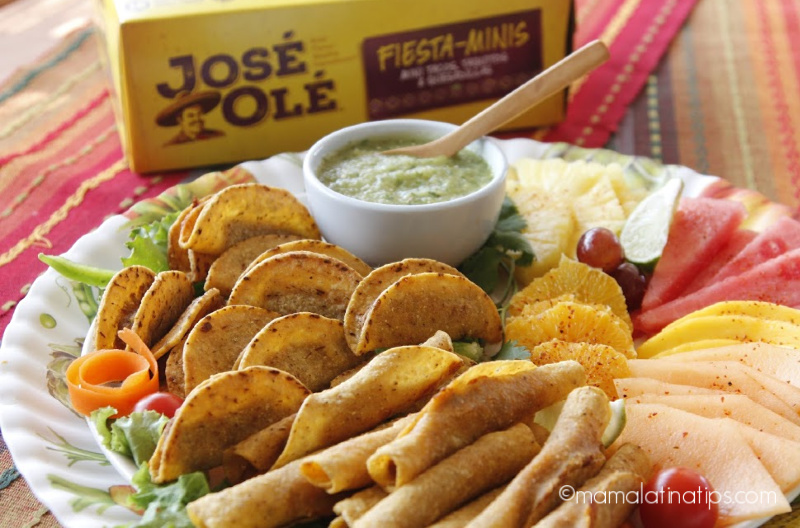 Jose Ole taquitos on a platter with salsa and fruit