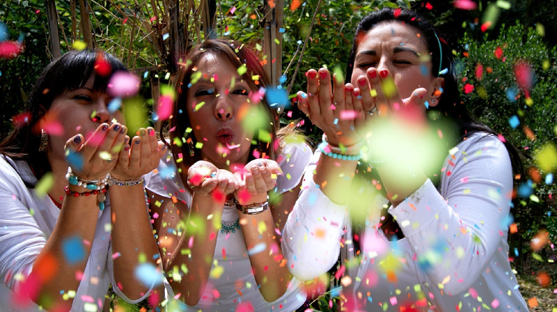 Ladies blowing confetti