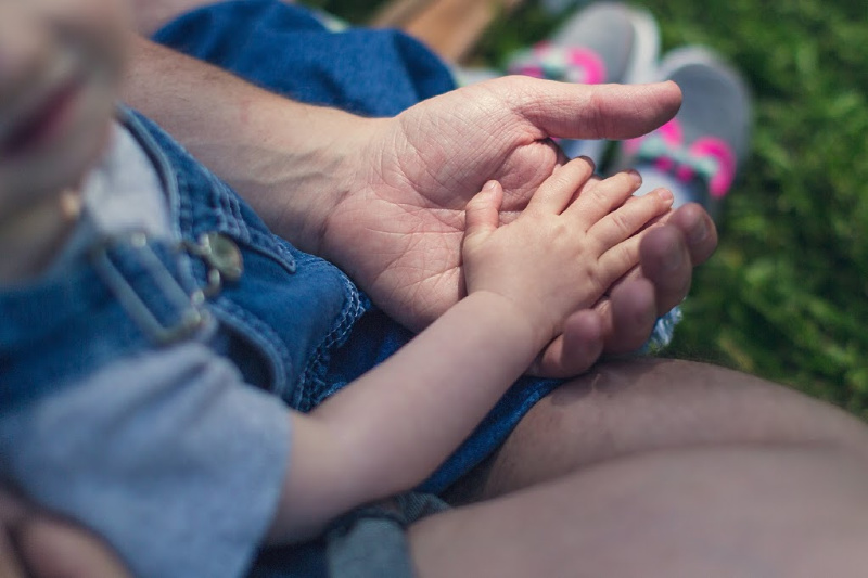 Kids hand on top grandparent's hand