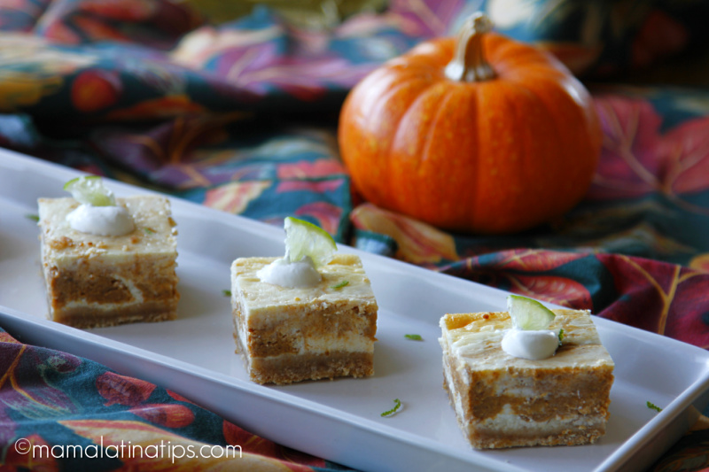 3 marbled pumkin lime cheescake bars in a long plate. In front of a pumpkin.