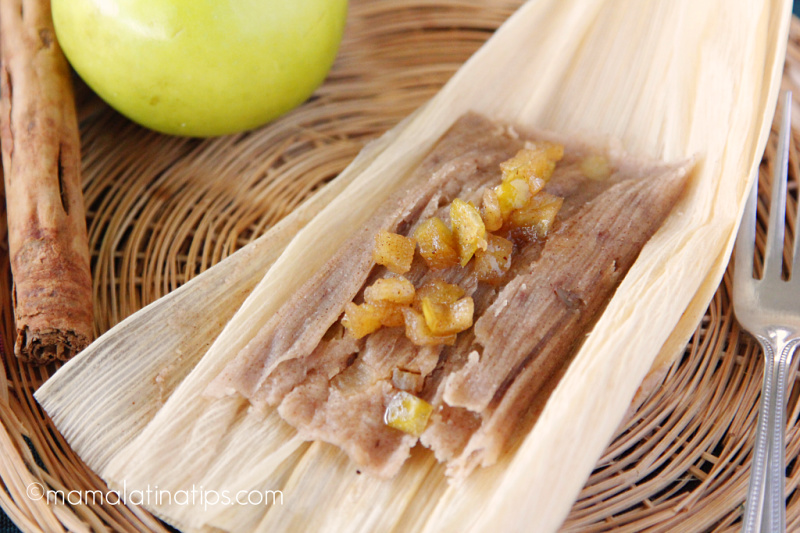 apple cinnamon tamal on a corn husk on top of a basket.