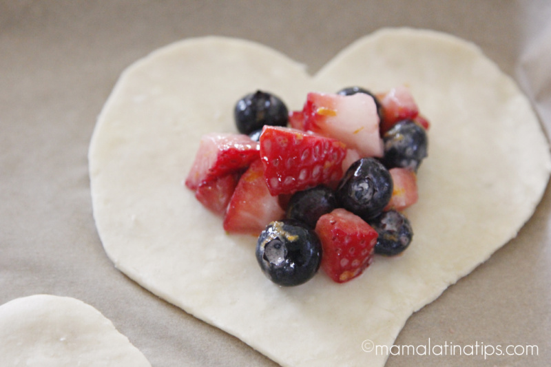 Chopped berries on top of a heart shaped dough