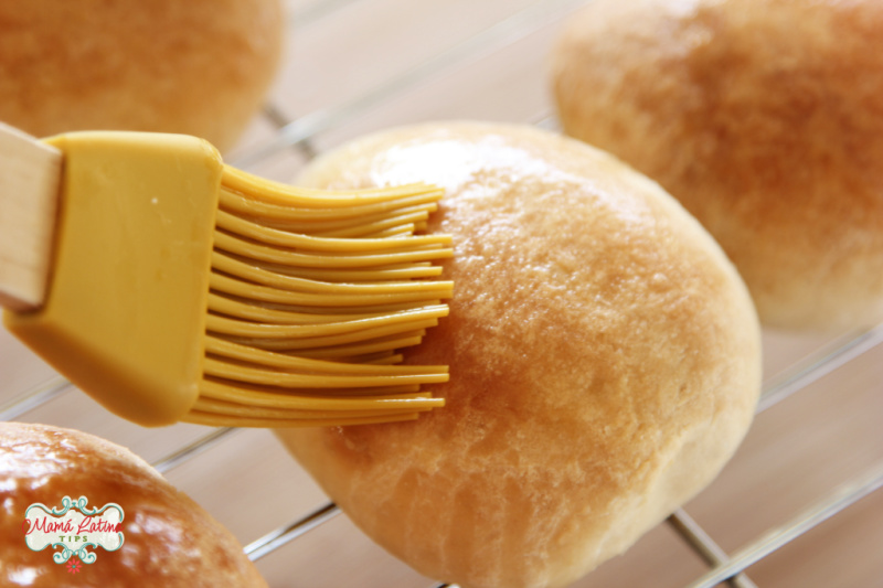 Spreading butter on fresh baked rolls