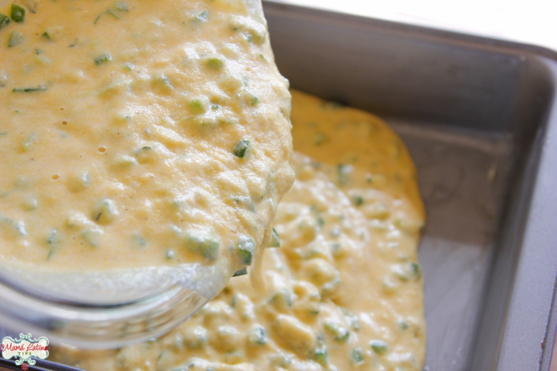 Pouring herbed jalapeño cornbread batter in baking pan