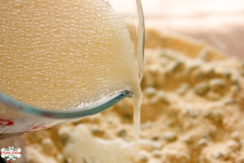 Pouring liquid ingredients on cornbread dry ingredients