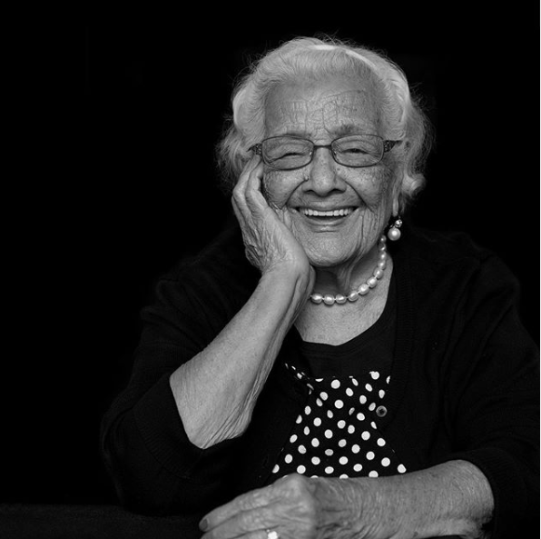 Black and white photograph of a female senior citizen smiling