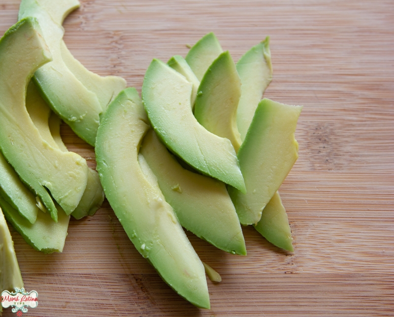 Sliced avocado on a wooden board