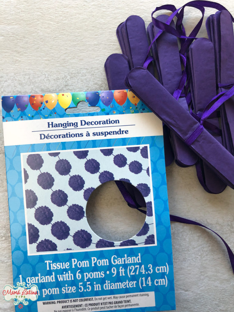Purple pom pom garland made of tissue paper.