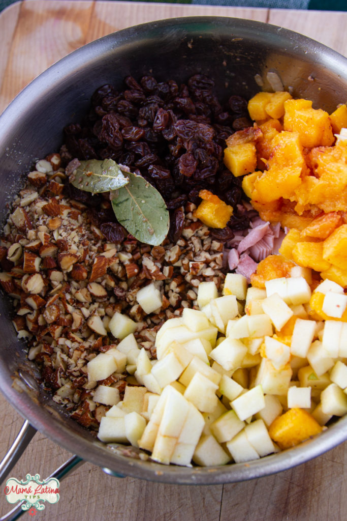 chopped apple, peach, nuts, and raisins in a pot