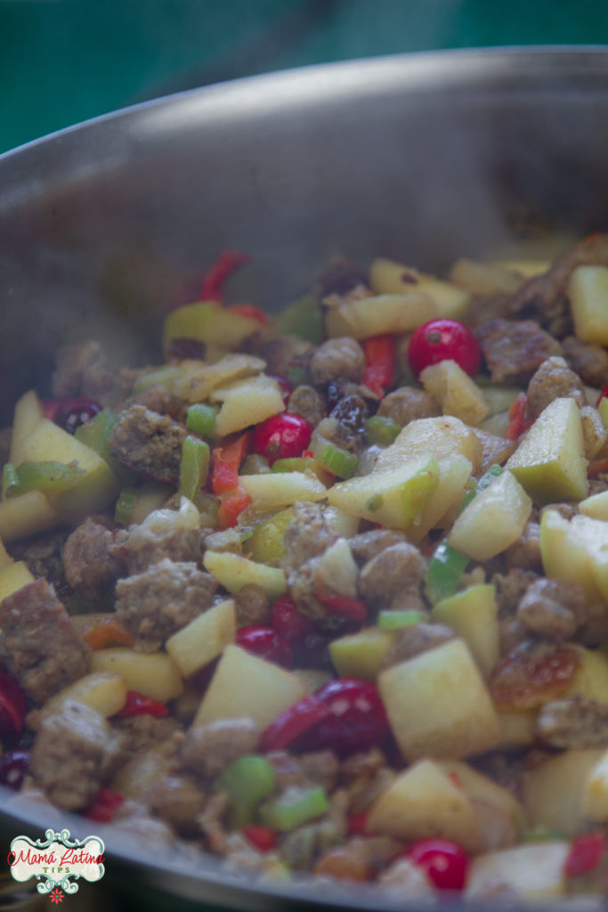 sausage, veggies and fruits cooking in skillet
