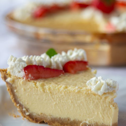 slice of Mexican cheesecake with whipped cream and strawberries