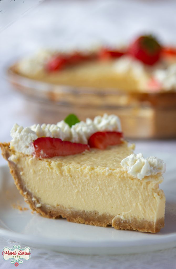 slice of Mexican cheesecake with whipped cream and strawberries