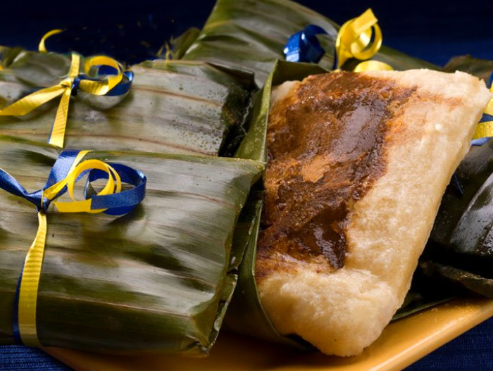 2 Oaxacan-Style Tamales in banana leaf with colorful ribbons