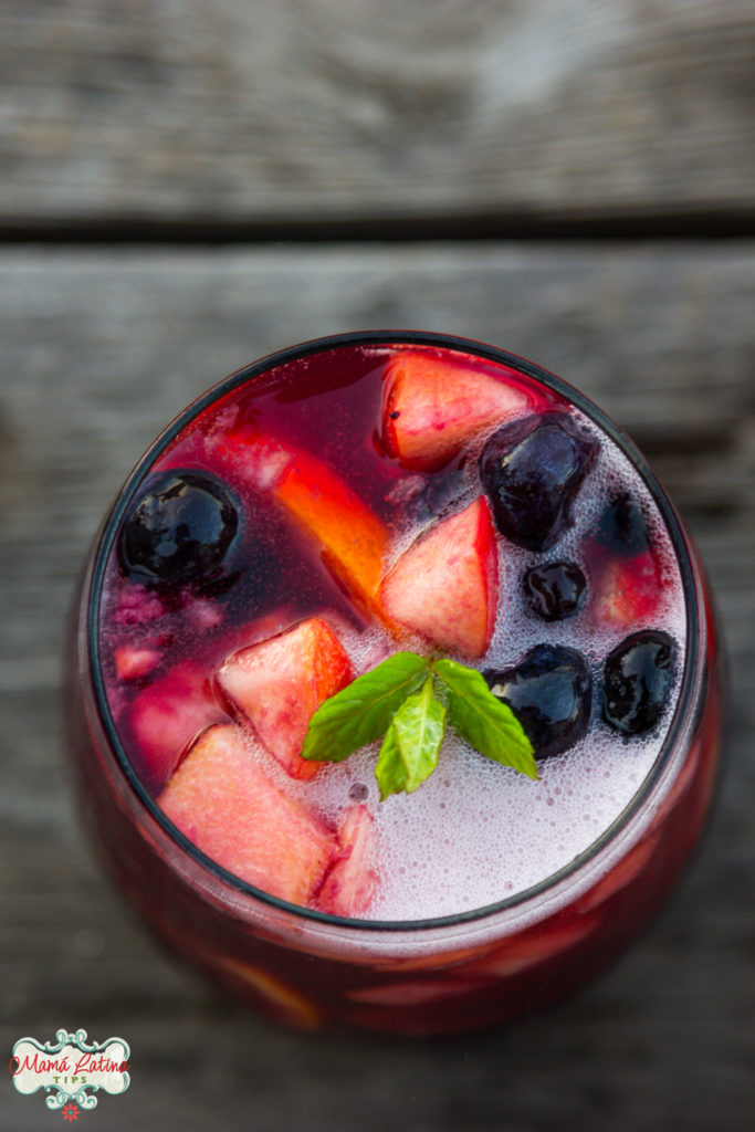 sparkling sangría with fruit and mint leaves in a glass