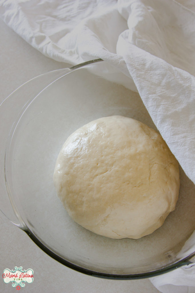 greased bread dough ball in a glass bowl