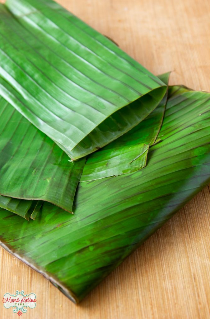 fresh banana leaves on top of a wooden table.