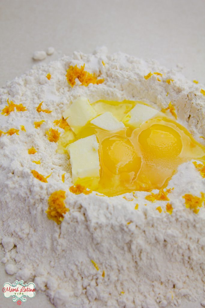 A flour well with eggs, butter and orange zest in the middle. 