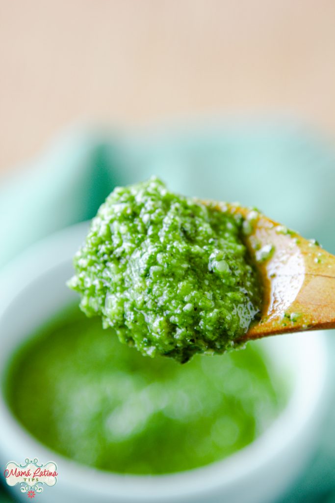A wooden spoon with pesto