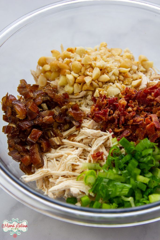 Chicken, dates, macadamia nuts, bacon and green onions chopped in a bowl