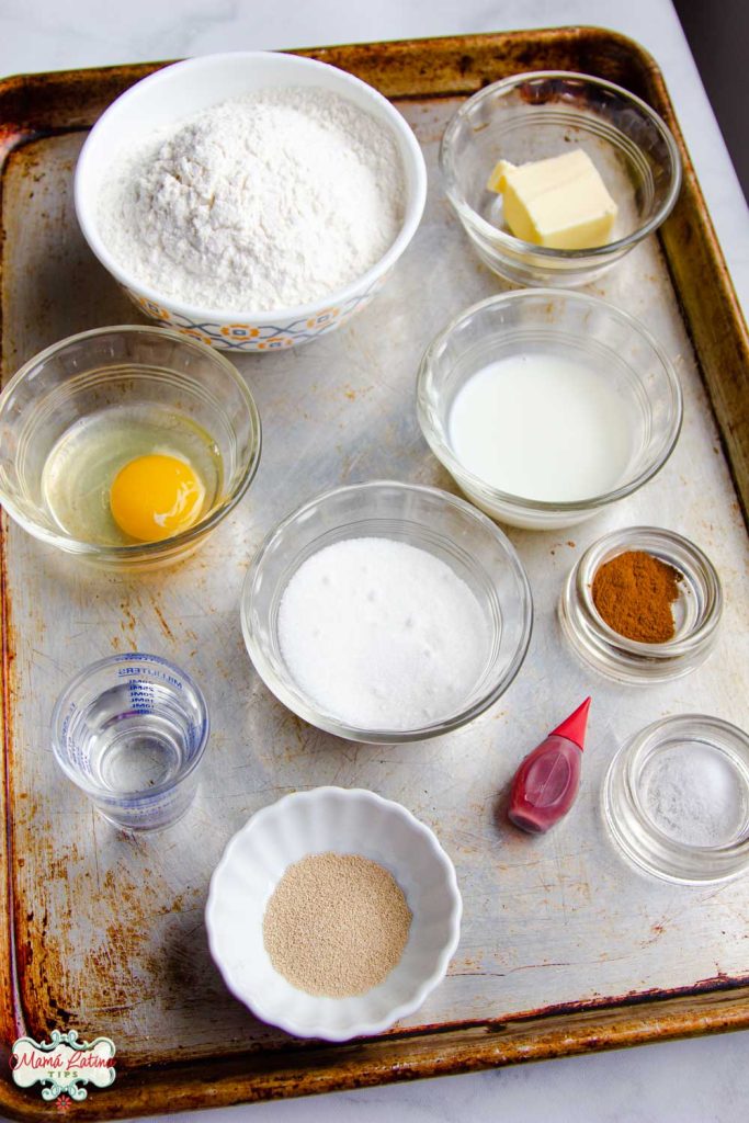 Flour, butter, egg, sugar, yeast, water, cinnamon, red coloring on a metallic baking sheet