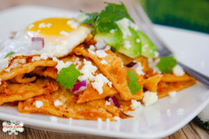 red chilaquiles with a sunny side egg on top