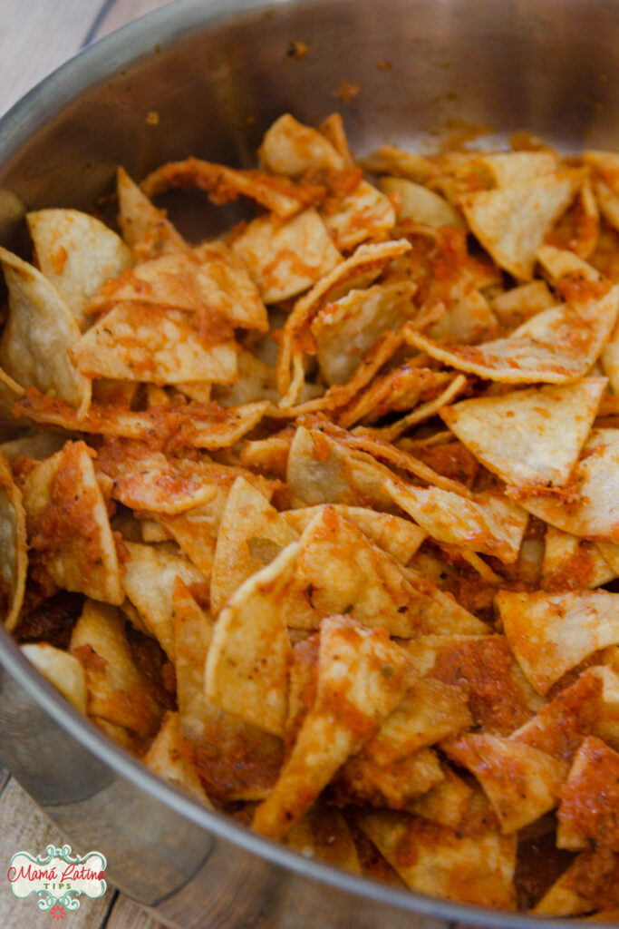 Tortilla chips coated with red salsa