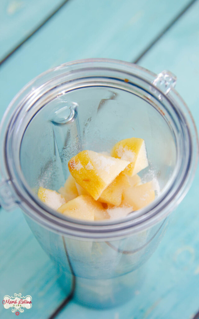 A smoothie cup with cubed quince fruit and sugar