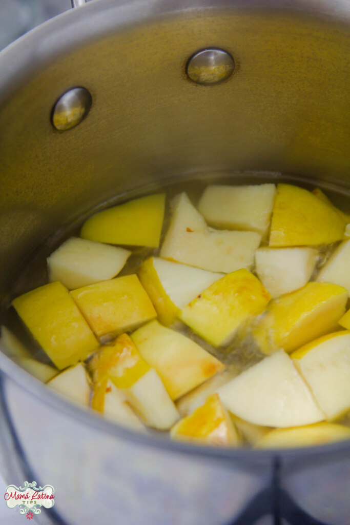 Cubed quince fruit with water in a pot