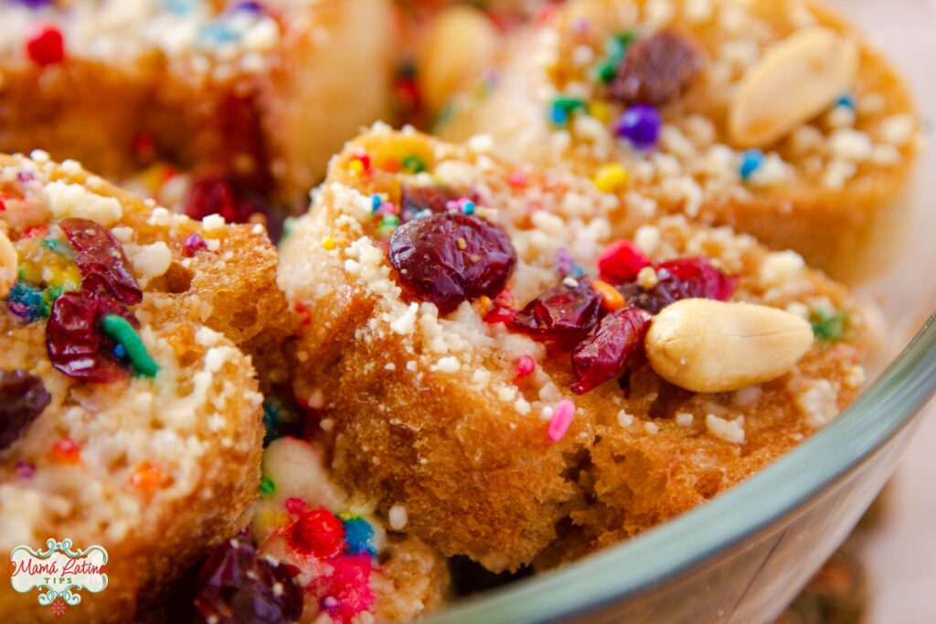 Close up of Mexican capirotada, topped with cranberries, peanuts and sprinkles.