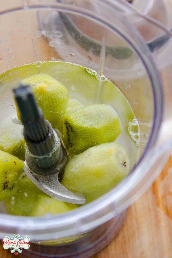 Kiwis and water in a blender