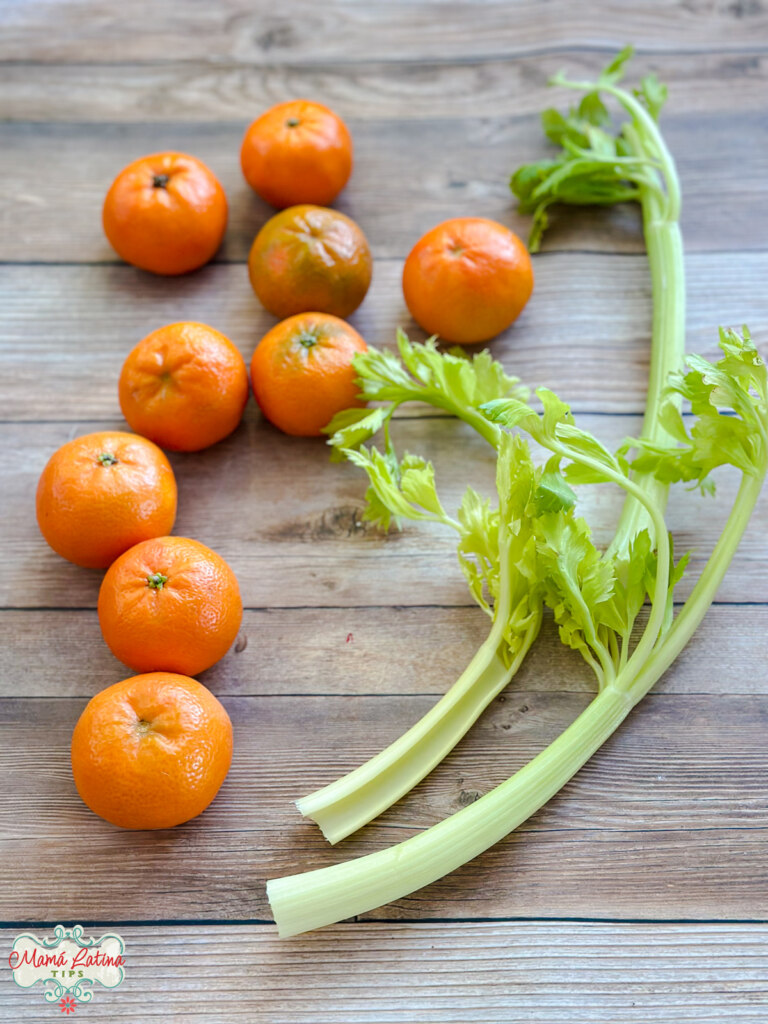 Oranges and celery on a wooden table