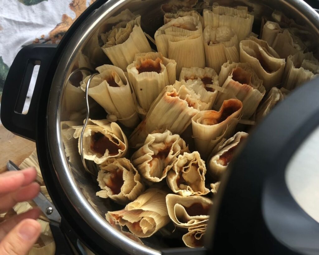A large batch of tamales in an instant pot.