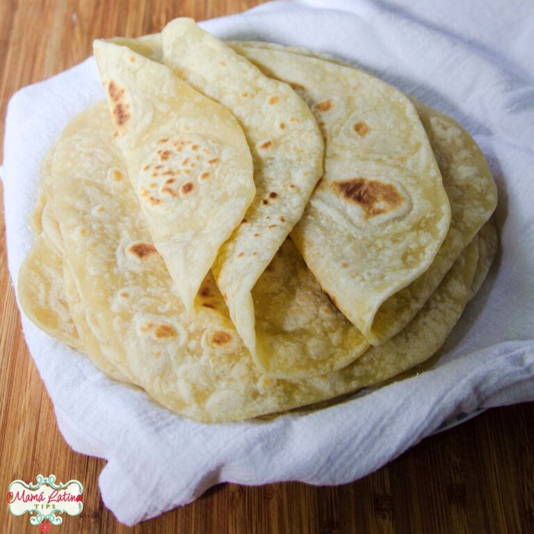 An easy homemade stack of flour tortillas on a white napkin.