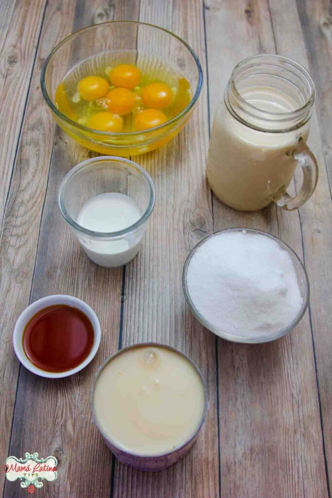 The ingredients for a flan recipe are shown on a wooden table.