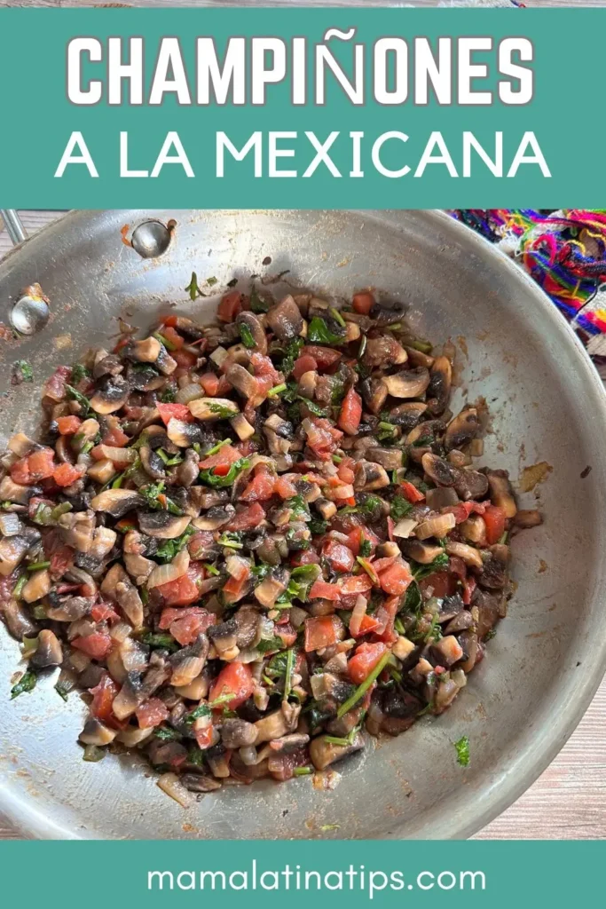 Una sartén llena de champiñones salteados, tomates, cebollas y hierbas, ilustrando el plato "champiñones a la mexicana".